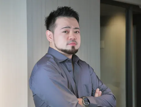 Photograph of CEO Ejima facing forward with arms crossed